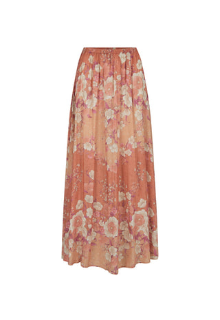 a-long-pleated-maxi-skirt-in-a-warm-peach-and-orange-floral-print-featuring-large-pink-and-cream-flowers-with-delicate-green-leaves-shown-against-a-plain-white-background