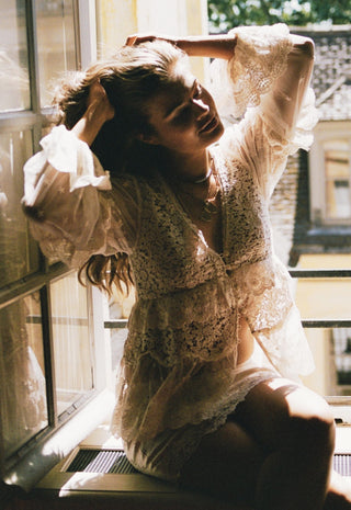  posed in warm sunlight near a window.